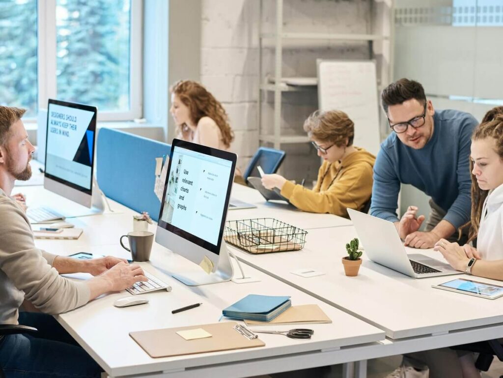 Employees focused on tasks at shared desk
