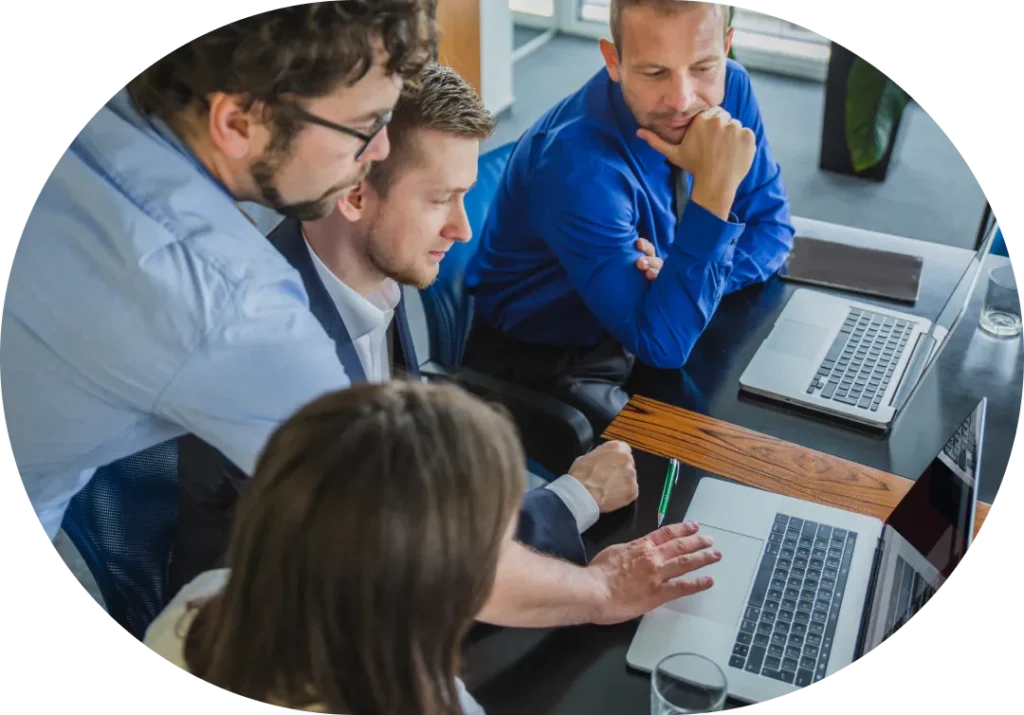 Group of professionals huddled together having a marketing discussion in an office setting